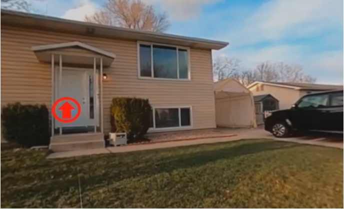 front yard of a beige house with clickable arrow on door _ in VR a viewer can enter by clicking the arrow